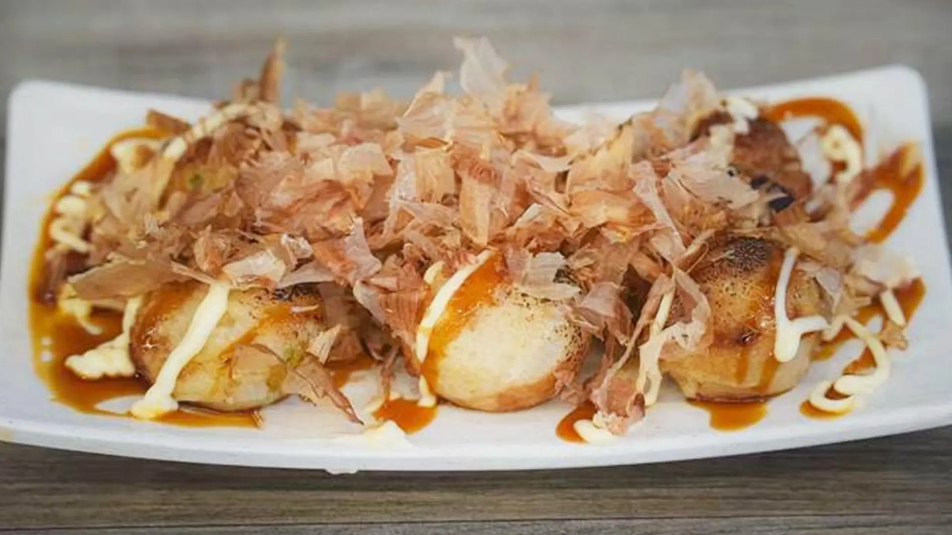 Savory takoyaki with octopus bits inside at Mala Mini Restaurant in Palisades Park.